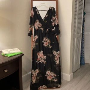 Floral dress. V neck and back. Bow around waist. Short black skirt underneath.